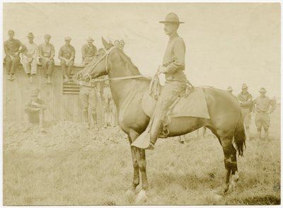 Soldiers Gathered Around and Watching a Uniformed Soldier on Horseback in a Grass Field by Carl Michel